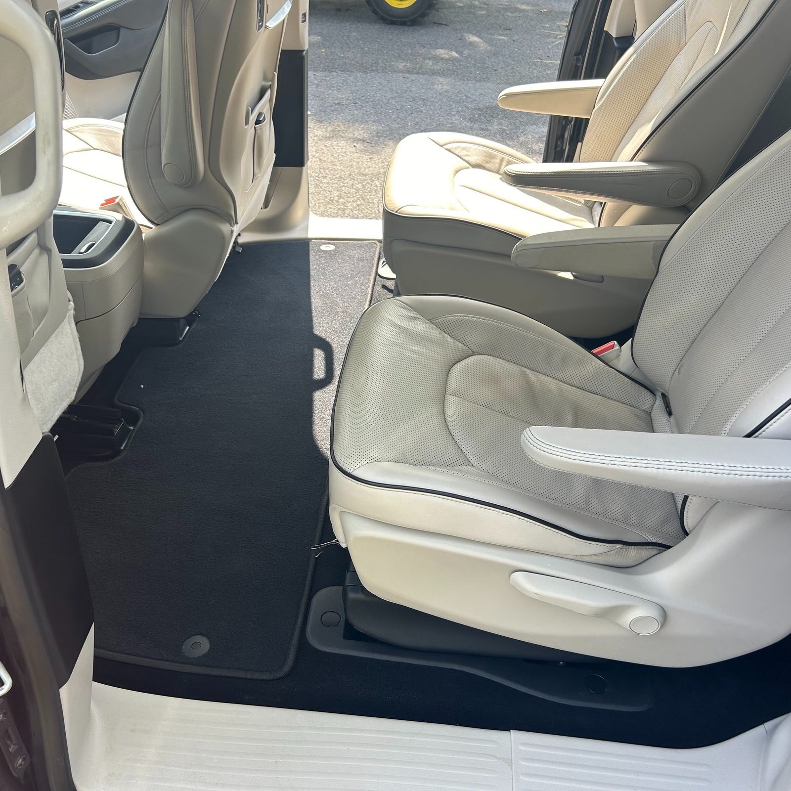 Freshly cleaned cream leather minivan interior at Next Level Auto Detailing