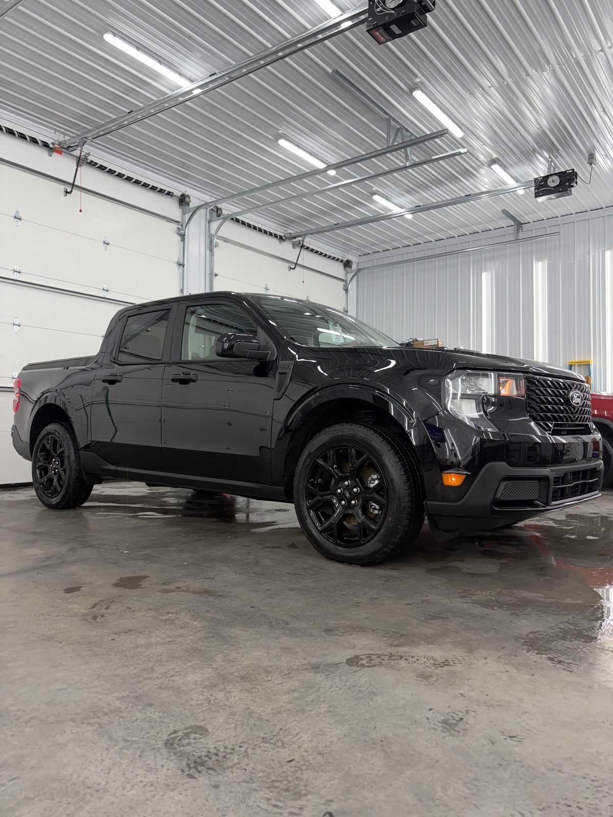 Black Ford Maverick with mirror-finish gloss after full detail at Next Level Auto